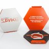 Peeksteep Spike Packing Tool, orange. Shown inside of the box